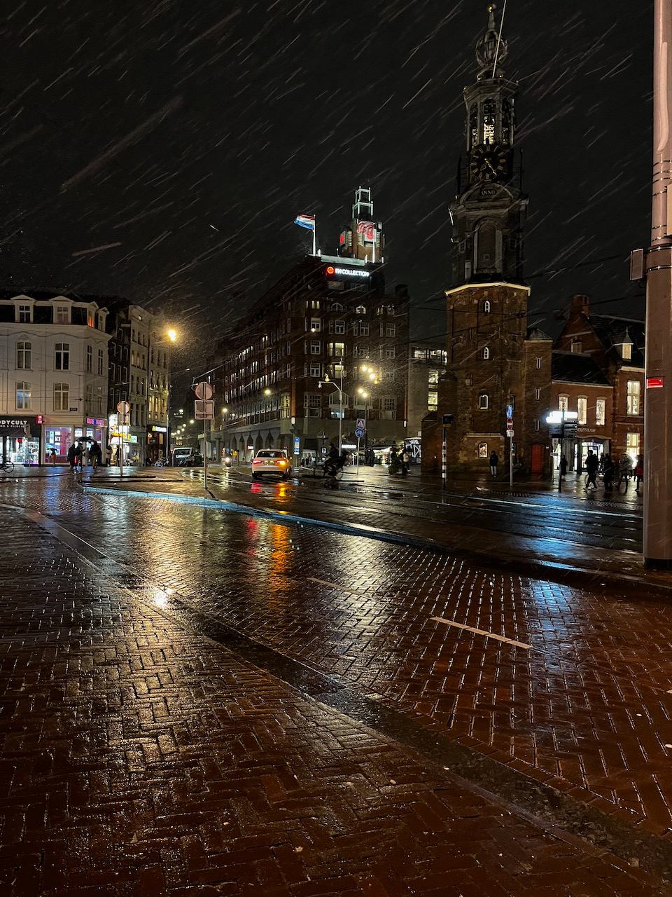 Snow on Amsterdam canal bridge